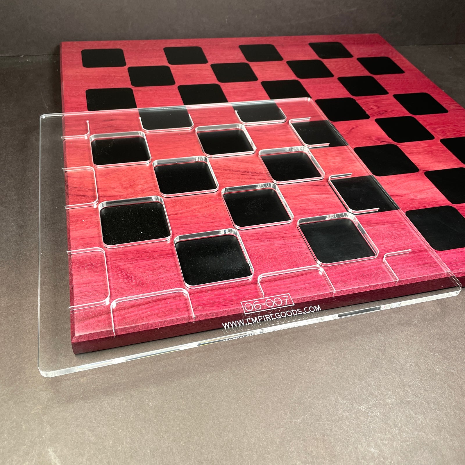 Clear acrylic template sitting on the front left corner of a chess baord