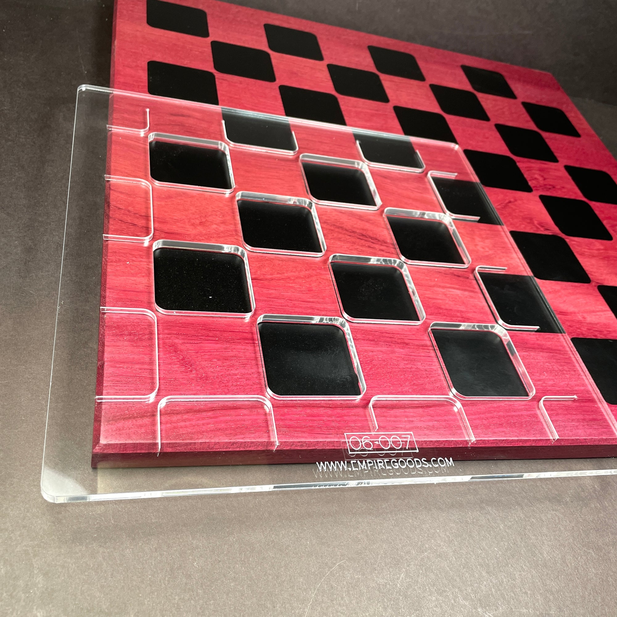 Clear acrylic template sitting on the front left corner of a chess baord