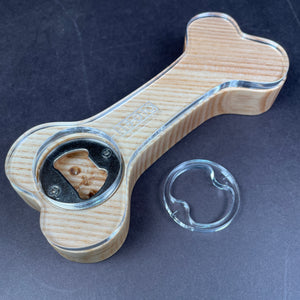 ash piece of wood with a clear one quarter inch 1/4" acrylic template laying on top to show customers how they can use it to profile out there piece of wood to look like a dog bone
