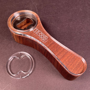 easy grip bottle opener made from walnut that has a lot of heart wood . Almost looks like a scaled down version of a baby rattle