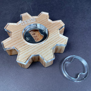 classic gear bottle opener that completed on a piece of ash with the beer opener positioned right in the middle of the circle with eight knobs sticking out